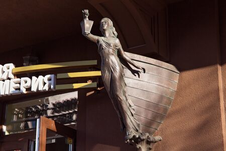 ZELENOGRADSK, KALININGRAD REGION, RUSSIA - APRIL 02, 2019: Sculpture of a girl with a lantern on the wall of a building in famous resort Zelenogradsk (formerly known as Cranz) on the Baltic Sea coast.のeditorial素材