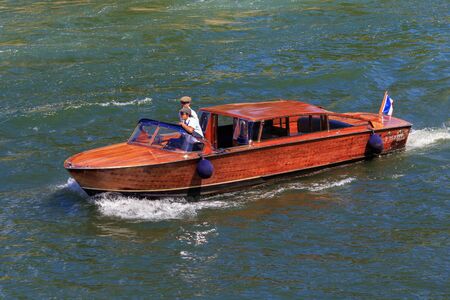 PARIS, FRANCE - JUNE 23, 2017: Red touristic wooden boat on the Seine river in the center of Paris.のeditorial素材