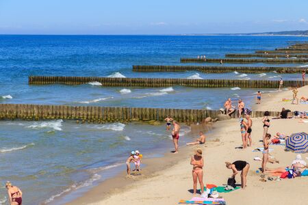 ZELENOGRADSK, KALININGRAD REGION, RUSSIA - JUNE 18, 2019: Unknown people resting on a sandy beach on the Baltic Sea coast in famous resort Zelenogradsk (formerly known as Cranz) at summer time.のeditorial素材