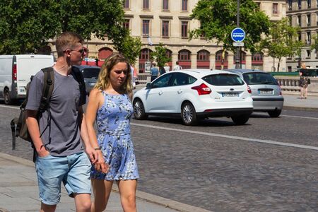 PARIS, FRANCE - JUNE 23, 2017: Unknown young couple walking near the cobblestone road in the center of Paris.のeditorial素材
