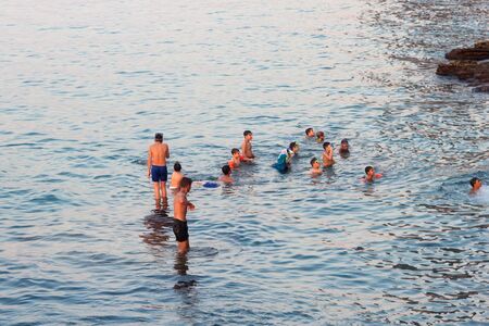 BEIRUT, LEBANON - AUGUST 14, 2014: Unknown people swimming in the blue water of the Mediterranean sea in the Raouche district in Beirut, Lebanon.のeditorial素材