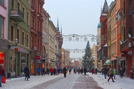TORUN, POLAND - JANUARY 08, 2016: Winter view of the Christmas tree and old buildings on the Szeroka street in historical part of town. Torun is one of the oldest cities in Poland.のeditorial素材