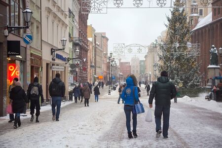 TORUN, POLAND - JANUARY 08, 2016: Unknown people wakling on the Rynek Staromiejski Square in historical part of town. Torun is one of the oldest cities in Poland.のeditorial素材