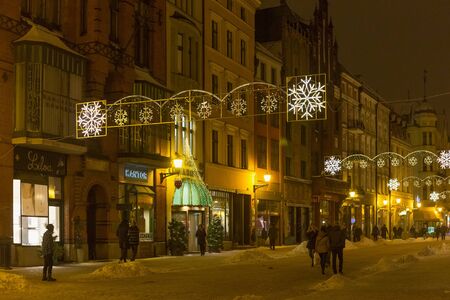 TORUN, POLAND - JANUARY 08, 2016: Night view of the old buildings with street Christmas decoration in historical center of city. Torun is one of the oldest cities in Poland.のeditorial素材