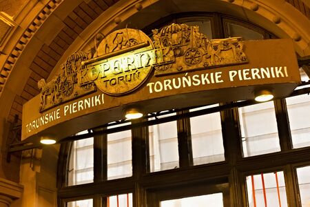 TORUN, POLAND - JANUARY 08, 2016: View of the signage of the bakery shop Torunskie pierniki Kopernik in the building known as Artus Court (built between 1889 and 1891) on the Rynek Staromejski square.のeditorial素材