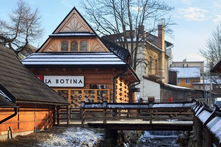 ZAKOPANE, POLAND - JANUARY 06, 2016: View of the old wooden building of the shoe shop La Botina in the historical part of the Zakopane near Krupowki street in sunny winter day.のeditorial素材