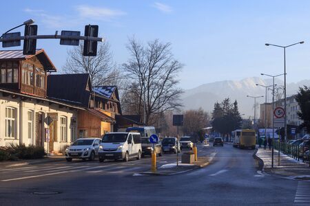 ZAKOPANE, POLAND - JANUARY 06, 2016: Winter urban cityscape with cars on the road and crosswalk in center of Zakopane in sunny day.のeditorial素材