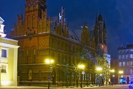 TORUN, POLAND - JANUARY 08, 2016: Night view of the Old Post Office red bricks building (Poczta Polska) on the Rynek Staromiejski street in historical part of the town.のeditorial素材