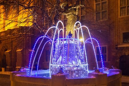 TORUN, POLAND - JANUARY 08, 2016: Night winter view of the fountain with the Christmas decoration in the historical part of the Torun on Rynek Staromiejski square.のeditorial素材