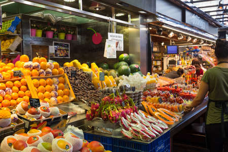 BARCELONA, SPAIN - MAY 16, 2017: Selling fresh fruits on the famous market La Boqueria in Barcelona.のeditorial素材