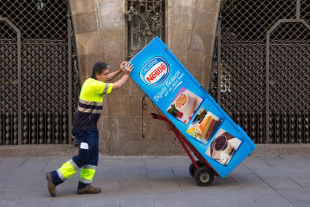 BARCELONA, SPAIN - MAY 15, 2017: Unknown worker take away coffee automat in center of Barcelona.