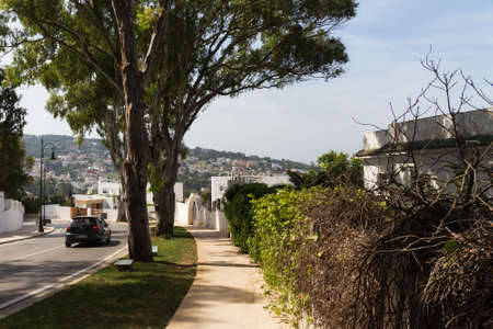 TANGIER, MOROCCO - MAY 27, 2017: Sidewalk near of the one of the automobile road in suburb of Tangier in sunny day.のeditorial素材