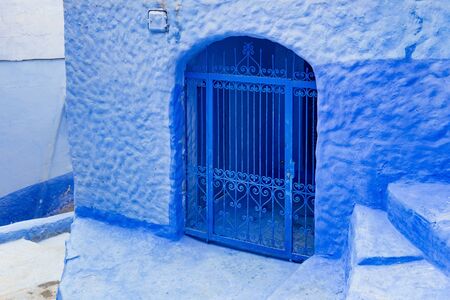 Old bars in house in Medina of Chefchaouen (Chaouen), Morocco. The city is noted for its buildings in shades of blue and that makes Chefchaouen very attractive to visitors.の写真素材