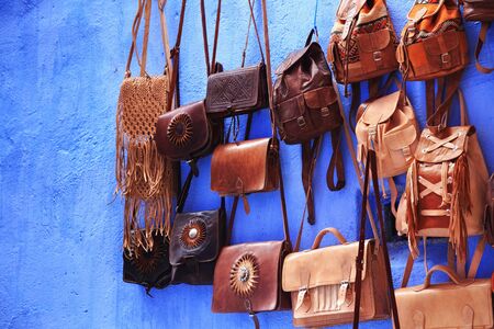 View of the leather bags in Medina quarter in Chefchaouen, Morocco. The city, also known as Chaouen is noted for its buildings in shades of blue and that makes Chefchaouen very attractive to visitors.の写真素材