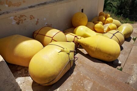 View of the yellow buoys on the ground in sunny day.の写真素材