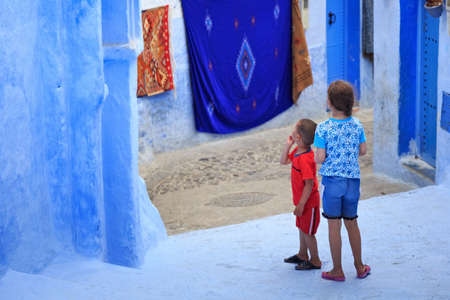 CHEFCHAOUEN, MOROCCO - MAY 28, 2017: Unknown locals children of Medina in Chaouen. The city is noted for its buildings in shades of blue and that makes Chefchaouen very attractive to visitors.のeditorial素材