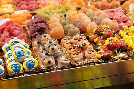 Different colorful cakes and other sweets on the market.のeditorial素材