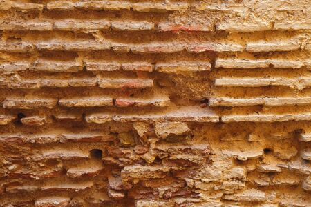Texture of the shabby ancient bricks wall.