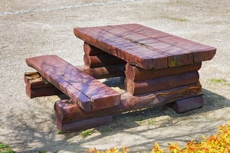 Wooden table in park on a sunny day.