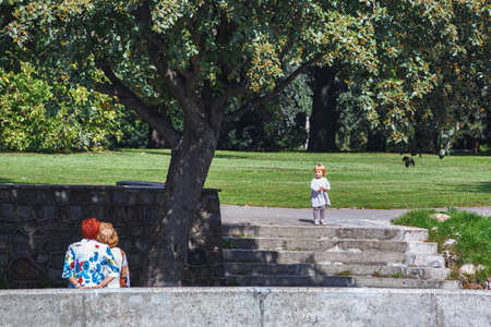 KALININGRAD, RUSSIA - AUGUST 22, 2019: Unknown elderly women with child in the city park on a sunny day.のeditorial素材