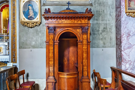 BERGAMO, ITALY - MAY 22, 2019: Old wooden confessional in the Sant'Andrea church in Bergamo. The church rebuilt by Ferdinando Crivelli in 1837.