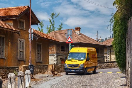 BERGAMO, ITALY - MAY 22, 2019: Minivan of the DHL company. DHL International GmbH is a German courier, parcel, and express mail service, a division of the logistics company Deutsche Post DHL.のeditorial素材