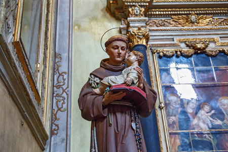 BERGAMO, ITALY - MAY 22, 2019: Statue of the man with the holy baby in hands in the Catholic Church of Sant Agata nel Carmine in Bergamo.のeditorial素材