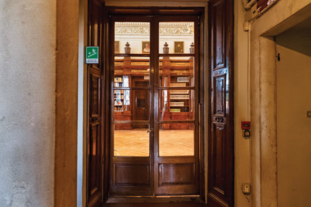 BERGAMO, ITALY - MAY 22, 2019: Wooden door to central hall in famous Bergamo library Biblioteca Civica Angelo Mai.のeditorial素材