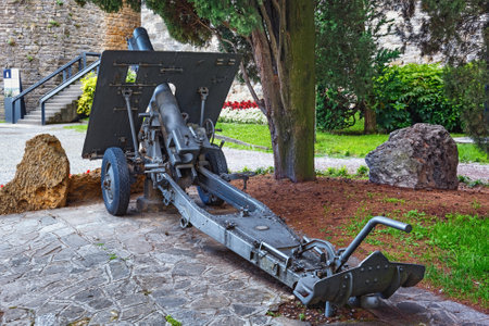 BERGAMO, ITALY - MAY 22, 2019: Old cannon weapon in the park of the Fortress of Bergamo (Rocca di Bergamo). The Museum at the Rocca di Bergamo is part of the Bergamo History Museum.のeditorial素材