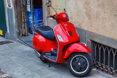 BERGAMO, ITALY - MAY 22, 2019: Red popular Italian scooter Vespa on the street in Bergamo.