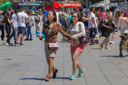 BARCELONA, SPAIN - MAY 15, 2017: Unknown young attractive asian women on the Placa Nova street (near...