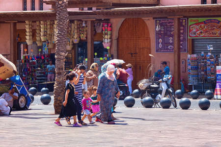 MARRAKESH, MOROCCO - JUNE 05, 2017: Unknown people in national clothes walking in the historic medina of Marrakesh on a sunny day.のeditorial素材