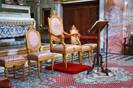 BERGAMO, ITALY - MAY 22, 2019: Wooden chairs near main altar in the Catholic Church of Sant Agata nel Carmine in Bergamo.のeditorial素材