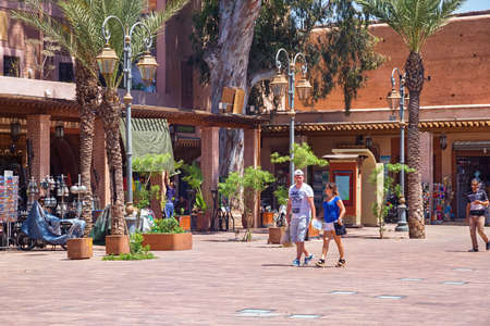MARRAKESH, MOROCCO - JUNE 05, 2017: Unknown people walking in the center of Marrakesh on a sunny...