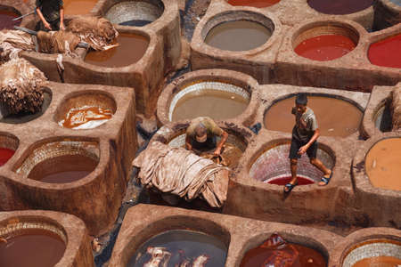 FEZ, MOROCCO - MAY 31, 2017: The tannery in Fez. The tanning industry in the city is considered one of the main tourist attractions. The tanneries are packed with the round stone wells filled with dyeのeditorial素材
