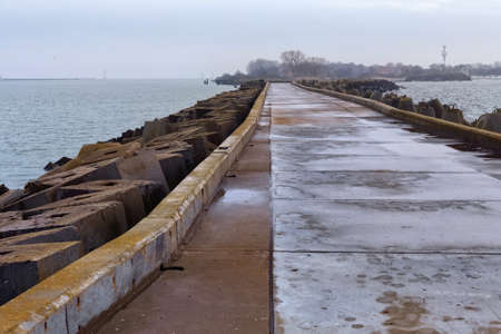 Long pier with the breakwaters on the Baltic Sea on the Vistula Spitの写真素材