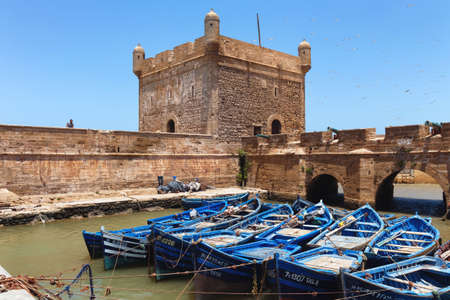 ESSAOUIRA, MOROCCO - JUNE 09, 2017: Famous fishing wooden blue boats moored near the ancient fortress of the Essaouira.のeditorial素材
