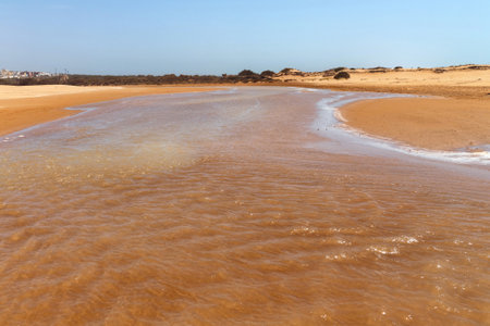 View of the shallow river among african sandy landscape near Atlantic ocean coast. Essaouira,...