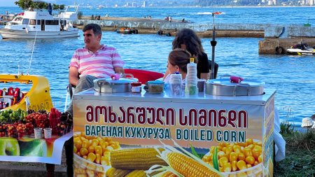 BATUMI, GEORGIA - JUNE 25, 2023: Sale of boiled corn in Batumi marina in city center resort on the Black sea.のeditorial素材