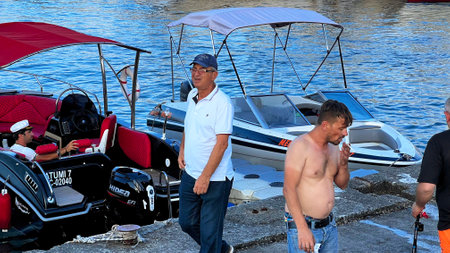 BATUMI, GEORGIA - JUNE 25, 2023: Unknown men near the motor boats in Batumi marina in city center resort on the Black sea.のeditorial素材