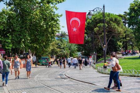 ISTANBUL, TURKEY - JULY 06, 2018: Unknown people walking under the Turkish national flag hanging in the center of Istanbul.のeditorial素材