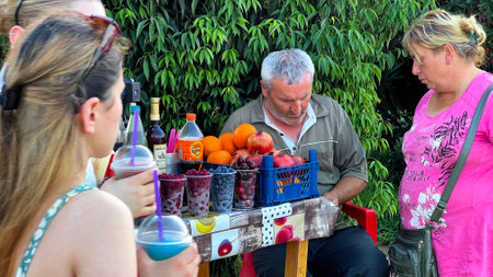 BATUMI, GEORGIA - JUNE 25, 2023: Sale of fresh fruits and berry sets in Batumi marina in city center resort on the Black sea.のeditorial素材