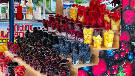 BATUMI, GEORGIA - JUNE 25, 2023: Sale of fresh fruits and berry sets in Batumi marina in city center resort on the Black sea.のeditorial素材