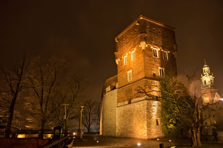 KRAKOW, POLAND - JANUARY 01, 2015: Medieval Thieves tower at night. Is tower one of the three extant fully towers at Wawel Castle. It was built in the XIV century in the line of gothic defensive wallのeditorial素材