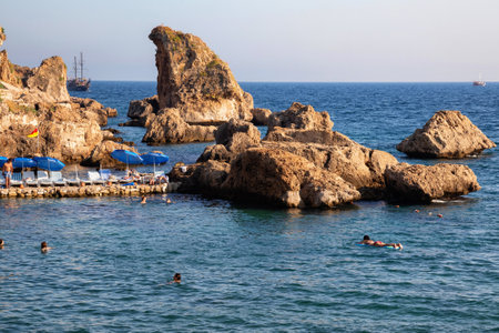 ANTALYA, TURKEY - JULY 08, 2018: Unknown people resting on the famous Mermerli beach in Antalya.のeditorial素材