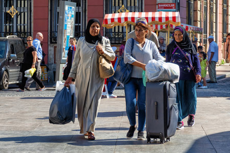 ISTANBUL, TURKEY - JULY 06, 2018: Unknown people with suitcases in the center of the Istanbul.のeditorial素材