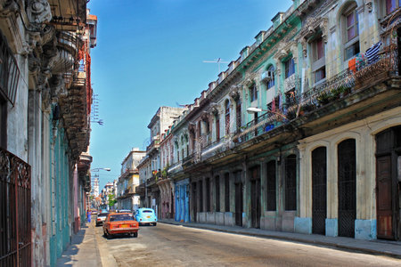 HAVANA, CUBA - MAY 14, 2012: View of a historic street with colonial buildings and vintage cars in the center of Havana.のeditorial素材