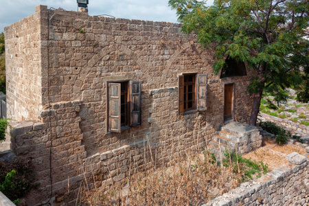 View of the old traditional Lebanese stone house in Byblos, Lebanon. The house is part of the ancient archaeological complex located next to it.のeditorial素材