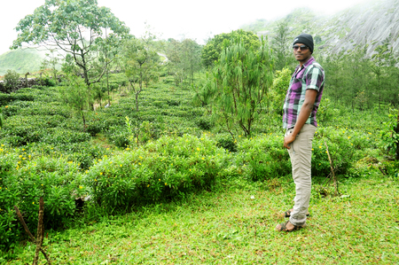 KODAIKANAL, INDIA - JUNE  30TH, 2015:  Portrait of a handsome young man in sunglasses on posing outdoor.のeditorial素材