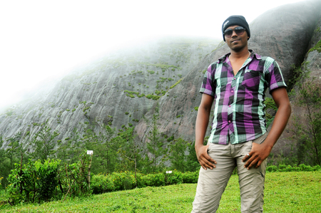 OOTY, INDIA - 30 JUNE, 2015: Portrait of a handsome young man in sunglasses on posing outdoor.のeditorial素材